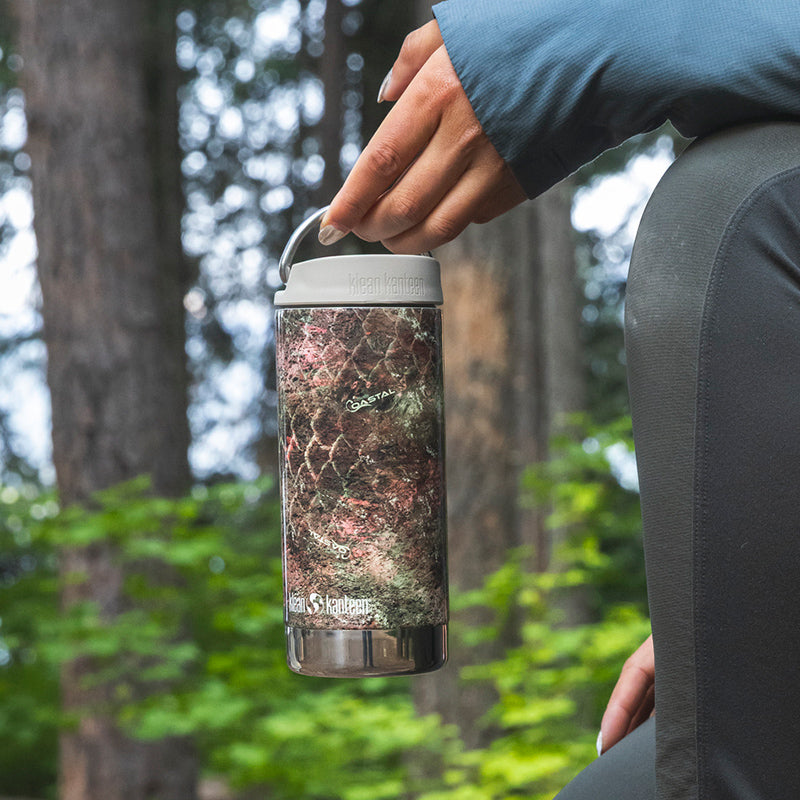 12oz-tkwide-with-twist-cap-mossy-oak-d7 12oz_tumbler_mossyoak_rainbowtrout_hand_closeup_square.jpg